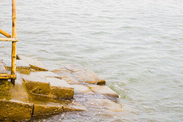 wooden stairs with concrete in the sea
