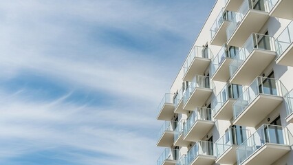Contemporary architecture showcasing sleek white balconies against a vibrant cloud filled sky backdrop