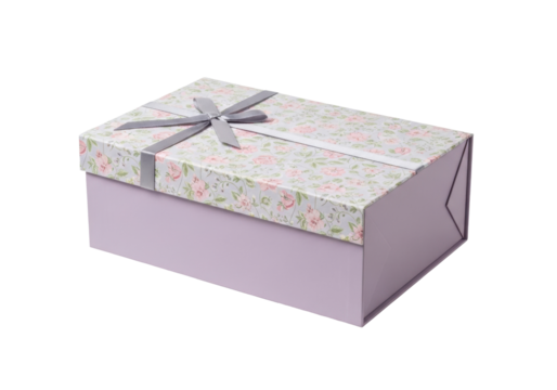 Isolated rectangular gift box with gray ribbon and floral top against a plain backdrop