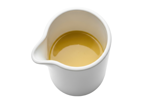 Isolated gravy boat filled with flavorful broth of clear consommé close up view, food photography