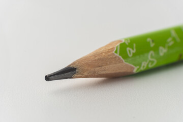 green pencil and eraser on white