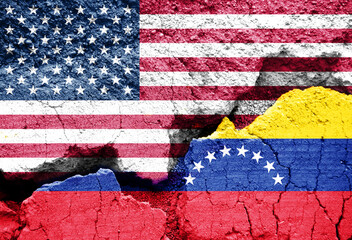 Flags of US and Venezuela on cracked ground background. Concept of conflict and tensions between...