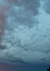 Brilliant sunset sky revealing magical colors behind gently floating evening clouds