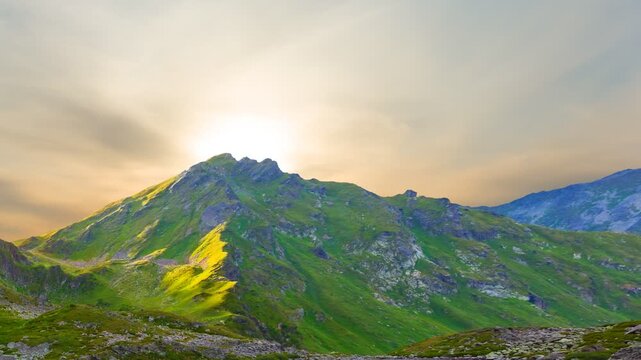 small blue lake in a mountain bowl, green mountain valey scene at the sunset time lapse scene