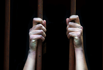 Sad young girl in prison