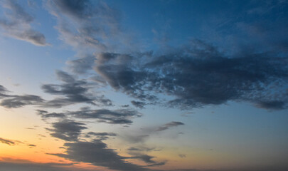 Majestic sunset sky shining through delicate clouds in peaceful afternoon light