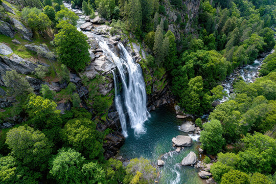 Aerial View of Waterfall Cascading into Lush Green Forest