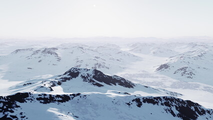 Under a soft winter sun, vast snowy mountains cascade into the distance, their peaks glistening. The tranquil scene evokes a sense of peace and the beauty of nature in winter.