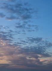 Stunning sunset sky casting magical hues across softly drifting afternoon clouds