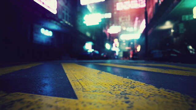 A narrow city alley glows with colorful neon signs at night. The wet pavement reflects the bright lights, creating a lively and dynamic atmosphere. A vivid representation of urban life.