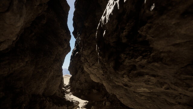 Sunlight shines through a narrow canyon, with towering rock formations on either side. Sandy ground leads deeper into the beautiful desert scenery, inviting adventure.