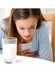 Woman Experiencing Stomach Discomfort Near Glass of Milk