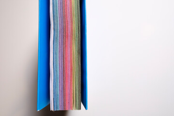 Close-up top view of colorful pages of a diary, white background