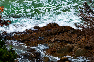 View of sea waves crashing against the rocks on the shore at Lorne, Victoria, Australia.