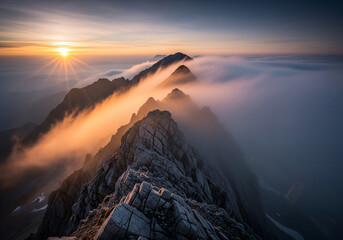 A breathtaking sunrise over a dramatic mountain ridge, where golden light illuminates a sea of fog and mist flowing through the majestic alpine landscape