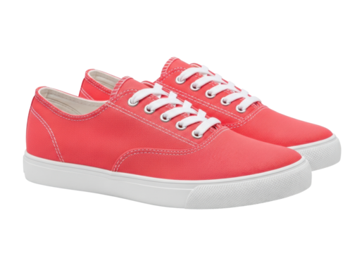 Isolated pair of casual coral sneakers with white soles, fabric shoes for summer footwear