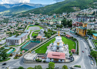 Aerial view of the majestic National Memorial Chorten contrasts with the city's modern architecture against a backdrop of towering mountains, Thimphu, Thimphu, Bhutan.