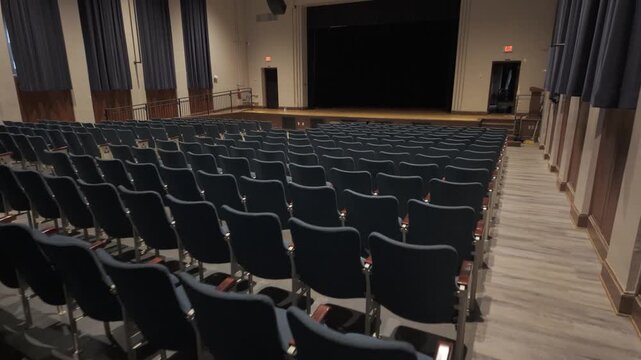 The empty seats of the high school theater await the arrival of students and performers for future events in this quiet space.