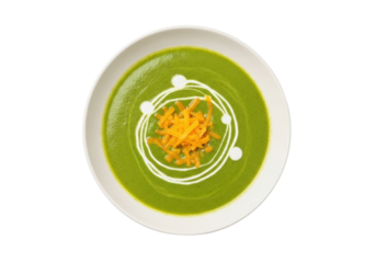 Isolated bowl of green soup with cream and cheddar cheese, on a table, overhead view