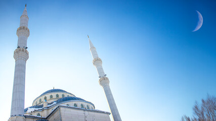 Ramadan or islamic background image. Haci Osman Efendi Mosque with crescent moon