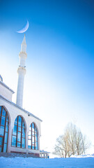 Ramadan or islamic vertical background image. Haci Osman Efendi Mosque with crescent moon