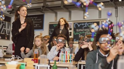 Immersive classroom experience, students engaged in holographic experiments, realistic 3D projections, smiling faces, teacher guiding exploration with joy, atmosphere of discovery and modern learning. - Powered by Adobe