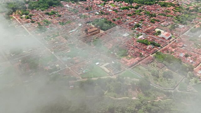 Aerial view of barichara, a colonial town in santander, colombia, emerging from the morning fog