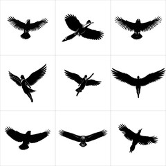 Black silhouettes of flying birds and winged figures isolated on white background