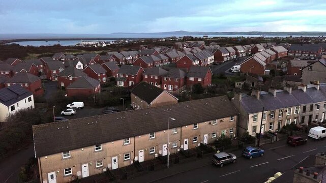 Holyhead town aerial view descending over old terraced property and new red brick build homes