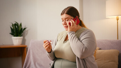 Body positive woman calls to share pregnancy news with husband