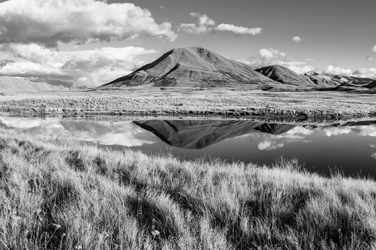 Landscape of Mount Guy reflected in the wateers of Lake Clearwater on the South island of New Zealand; nature landscape of alpine mountain range and clear water lake
