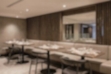 Blurred image of restaurant with light and bokeh for background usage. Blur interior background concept.