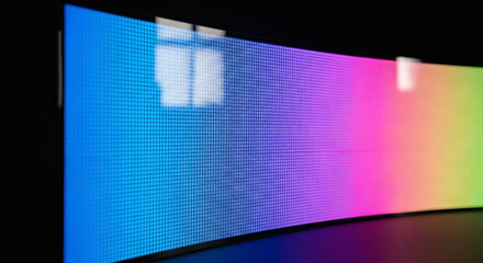 Vibrant curved display with spectrum of colors creates modern tech aesthetic for digital media, perfect for technology, innovation, and creative backgrounds