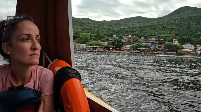 Boat trip on the Concei&ccedil;&atilde;o Lagoon in Florian&oacute;polis, Brazil. Woman enjoys the scenery.