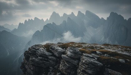 Moody rocky ridge above misty mountain valley at dawn, symbol of resilience and climate awareness in alpine landscape of italy and austria