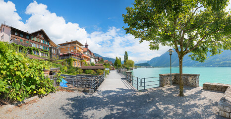idyllic walkway lakeside Brienzersee, pictorial houses and gardens, destination Bernese Oberland