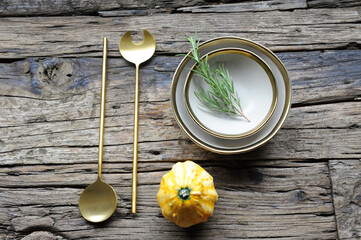 Rustic Autumn Table with Decorative Pumpkin, Rosemary, and Golden Spoons