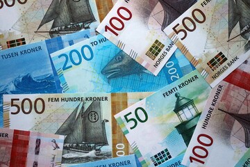 Norwegian Krone currency money bills. NOK currency banknotes in heap with different denomination...