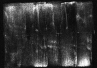 Grunge vertical white paint brush strokes on black surface background. Distressed rough smudge and smear graphic element.