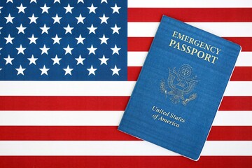 United States emergency passport book on US flag close up. Travel document on official banner photo