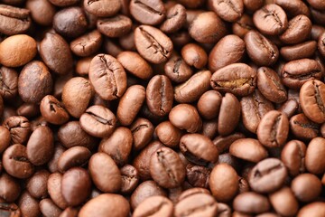 Textured background of freshly roasted coffee beans close up