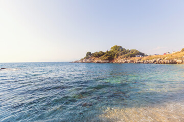 Obraz premium Shallow clear turquoise sea water meeting rocky mediterranean cove