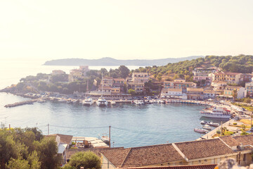 Aerial view of Kassiopi port and village in Corfu, Greece, on sunny day