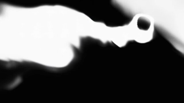 Abstract image featuring a flowing white shape against a dark background, creating a sense of motion and fluidity.