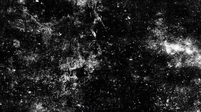 A textured black and white surface with abstract patterns resembling a cosmic scene, featuring scattered white specks and dark areas.