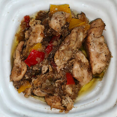 Cooked Chicken Pieces with Bell Peppers in White Dish