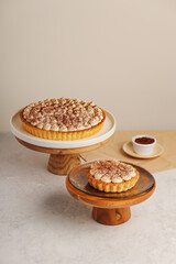 Elegant Tiramisu Tarts with Whipped Cream and Cocoa Dusting on Cake Stands