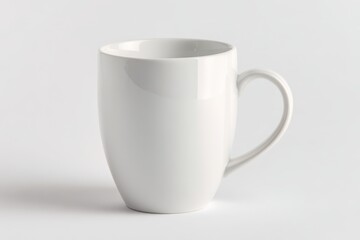 Obraz premium White ceramic mug isolated on seamless white background with soft studio lighting
