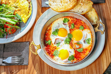 Delicious Shakshuka with Poached Eggs and Fresh Herbs, Mediterranean Brunch