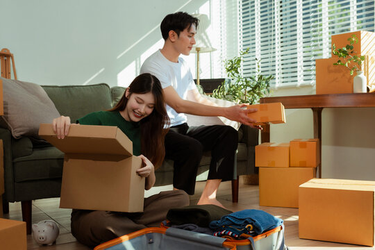 young couple helps put things in boxes and prepares to move to a new house.